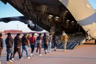 Deportees entering a US military plane