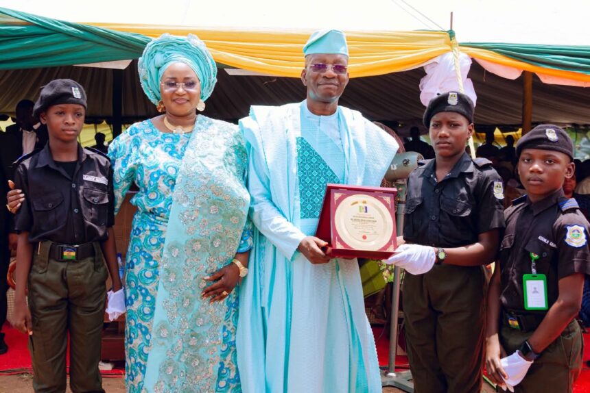 Rtd. IGP Kayode Adeolu Egbetokun, flanked by his wife Mrs. Elizabeth Egbetokun (L) receives award from the students of Police Secondary School School, Erinja at the Welcome Home Celebration organized in his honour on Saturday, 18th April, 2026.